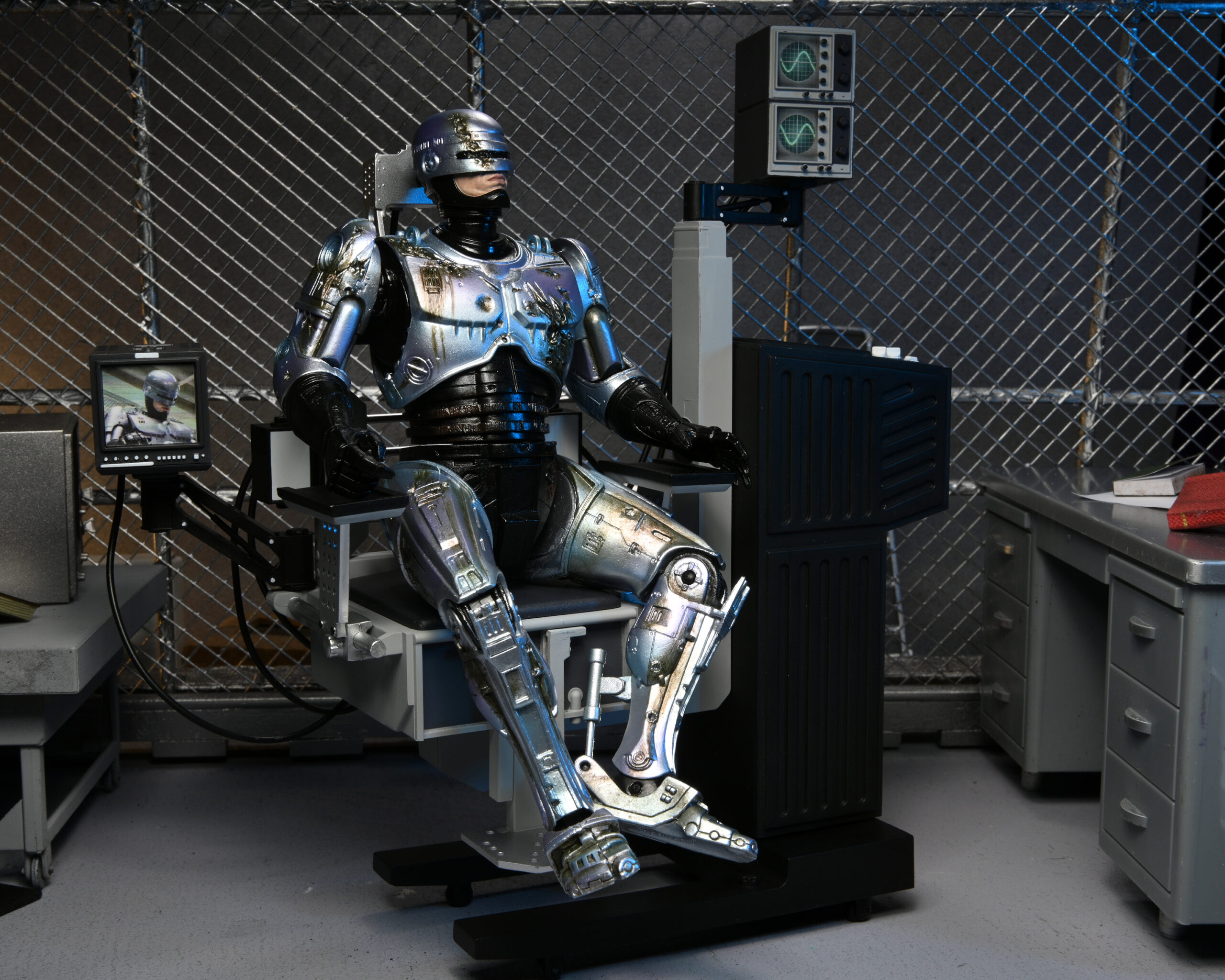 NECAOnline.com | RoboCop - 7" Scale Action Figure - Ultimate Battle-Damaged RoboCop with Chair